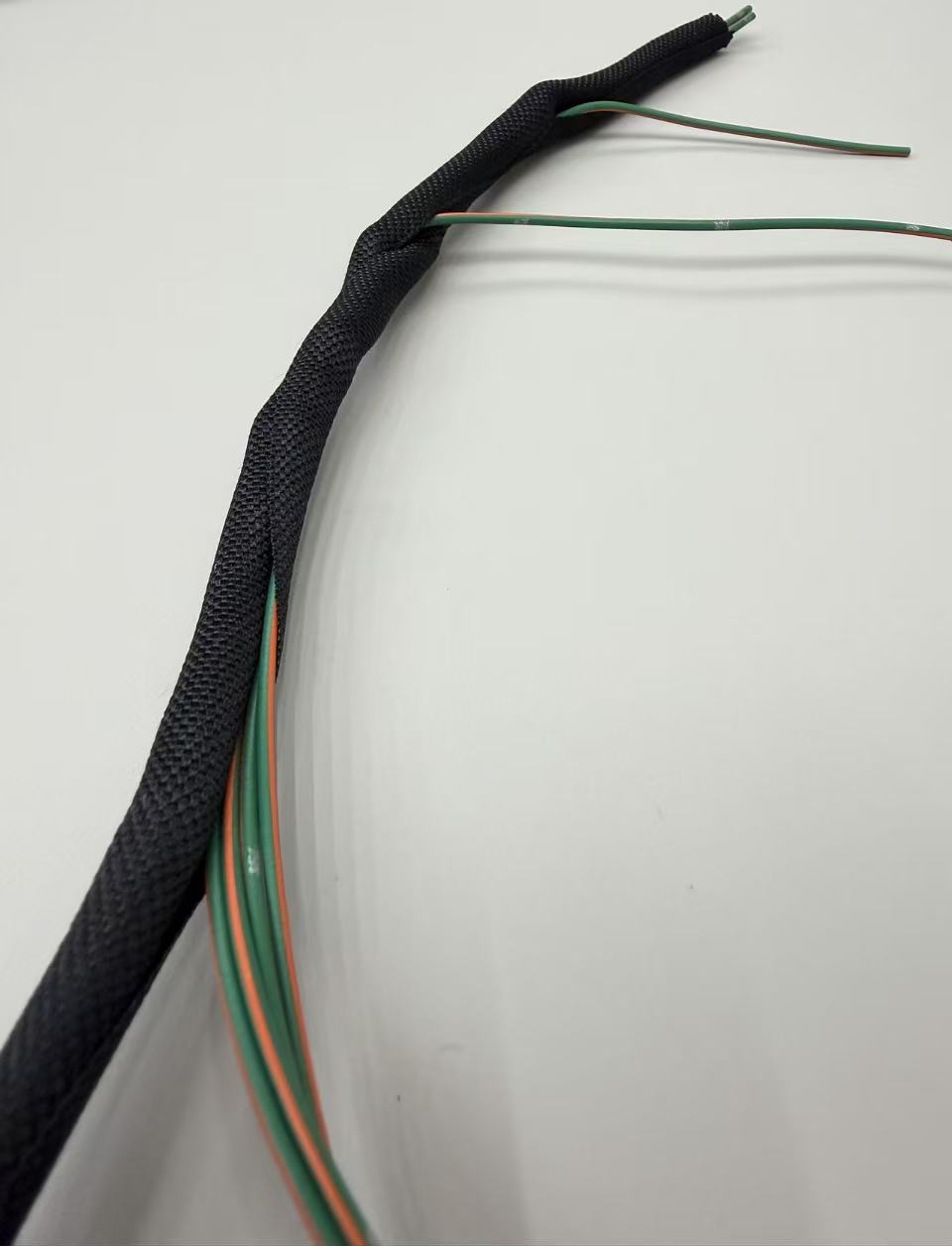 PETV Wraparound braided sleeving for automotive wire assembly